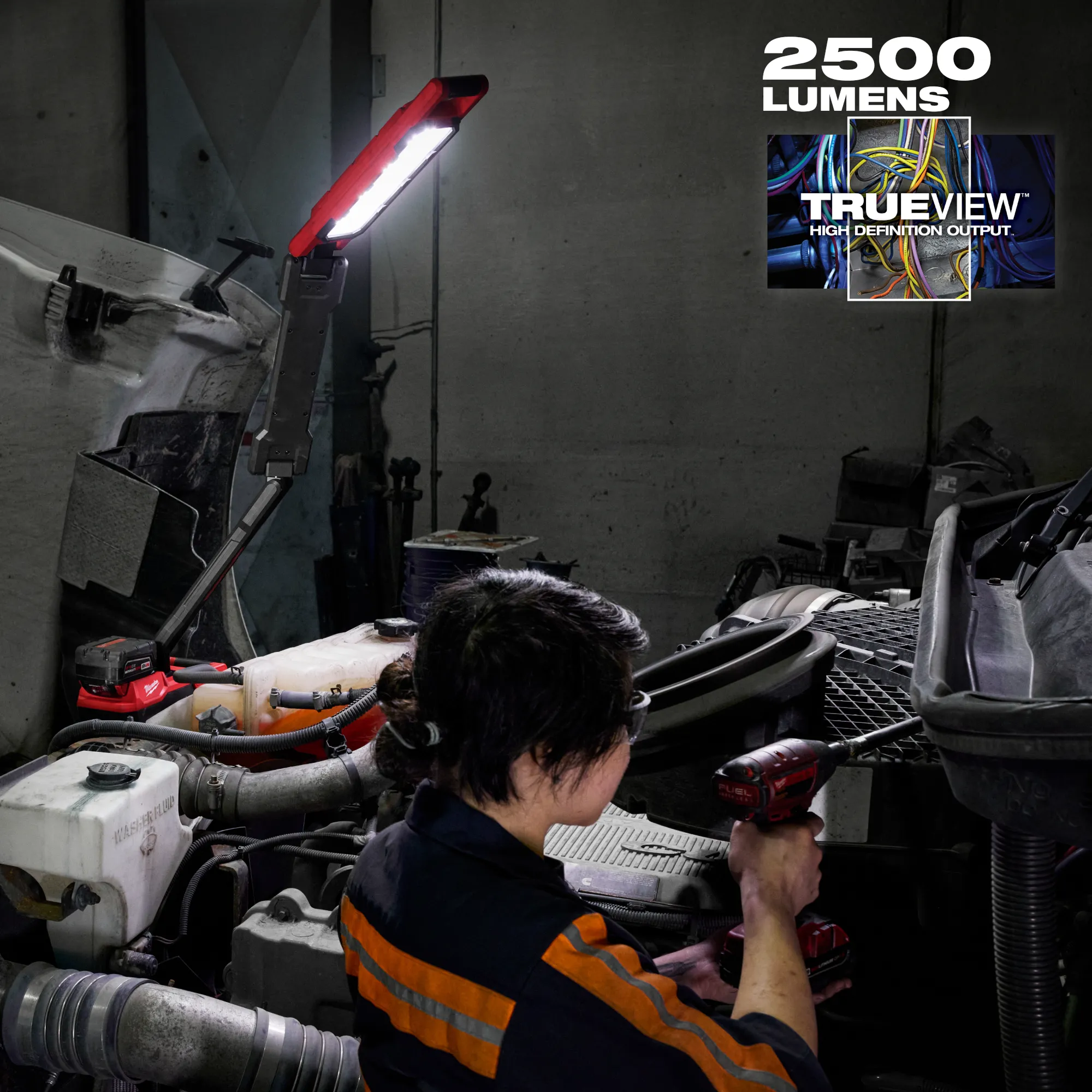 Image of a mechanic using the Milwaukee M18 Magnetic Extendable Boom Light on the jobsite