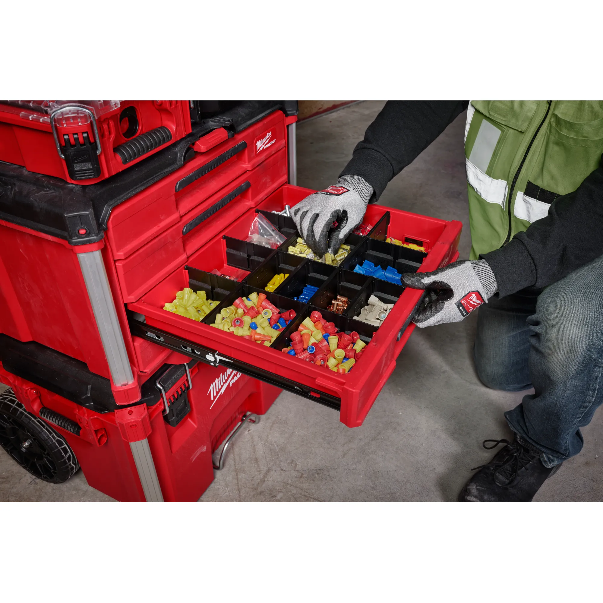 Worker going through the PACKOUT 4-Drawer Tool Box 